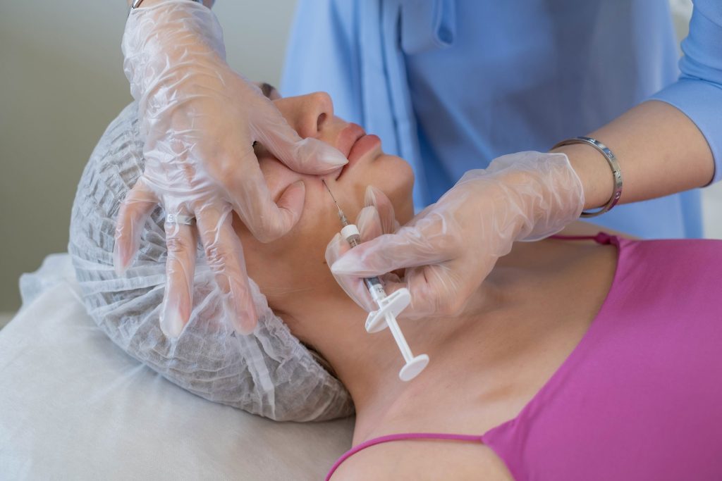 woman receiving precise injections in her lips for dermal fillers at Revive and Drip, where enhancing natural beauty is a priority. This procedure is part of the wide range of aesthetic treatments offered at Revive and Drip, including Botox, fillers, IV therapy, and weight loss treatments. Each treatment is carefully administered to ensure the best results, helping clients achieve their desired look with professional and medically supervised care.