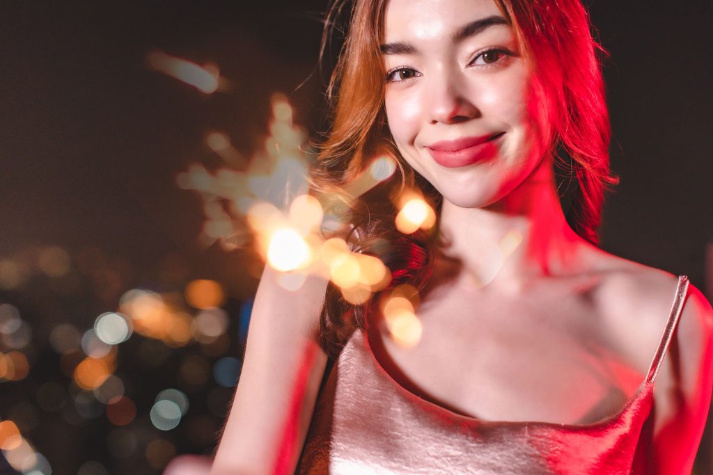 a woman holding a sparkler