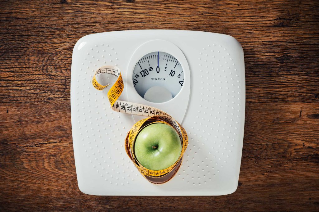 Image of a scale with a vibrant green apple and a measuring tape, symbolizing the focus on health, wellness, and weight management through the Metabolism Multiplier IV Therapy offered at Revive and Drip Medical Spa. This image represents the key elements of boosting metabolism and supporting weight loss, which are central to this IV therapy. The green apple and measuring tape highlight the commitment to natural, effective solutions for enhancing metabolic function, helping clients achieve their weight loss and wellness goals. In addition to IV therapy, Revive and Drip offers a comprehensive range of services including Botox, dermal fillers, aesthetic treatments, and specialized weight loss programs, all tailored to meet the individual needs of each client. The combination of these visual elements underscores the spa’s holistic approach to health and beauty, where science-based treatments are provided in a luxurious, supportive environment to ensure the best possible outcomes for clients seeking to improve their metabolism and overall well-being.