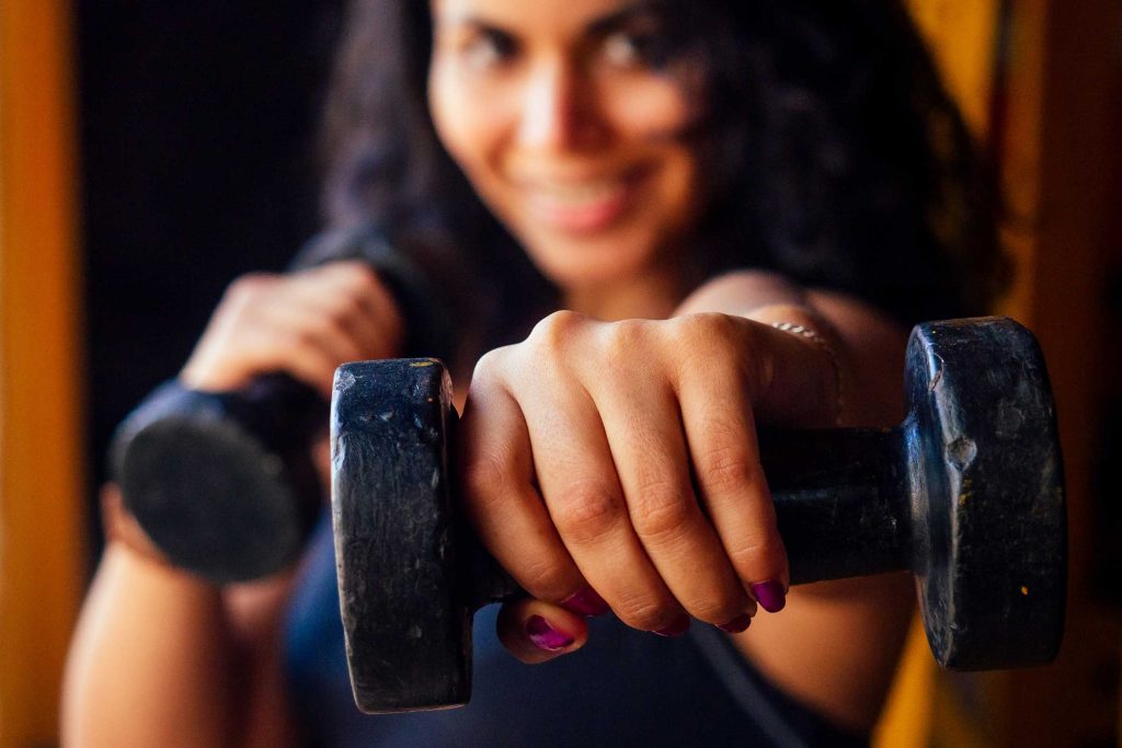 a woman holding weights in her hand