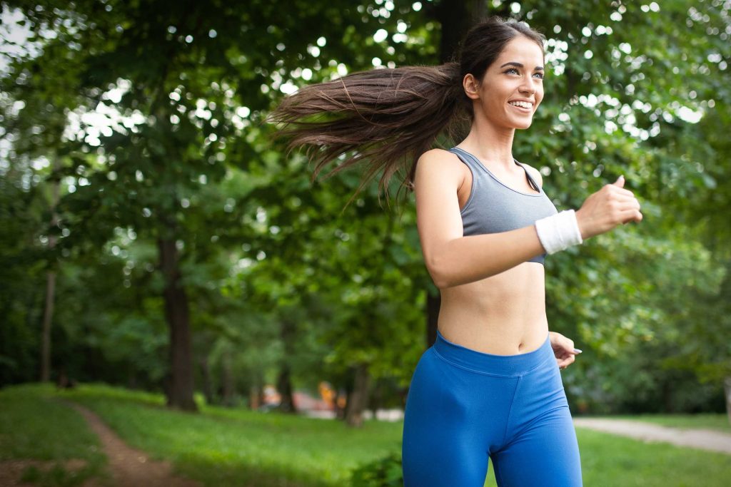 a woman running in a park